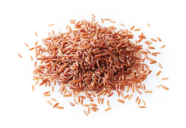 istock Heap of uncooked red rice isolated on white background 1310280722