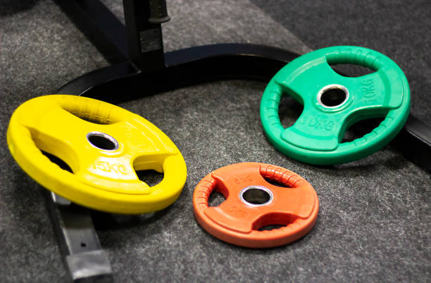 istock multicolored barbell plates lie on the floor in the gym 1310281992