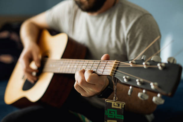 istock A musician is playing on acoustic guitar close up view 1310282218