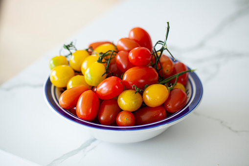 Yellow and Red cherry tomatoes inside a bowl