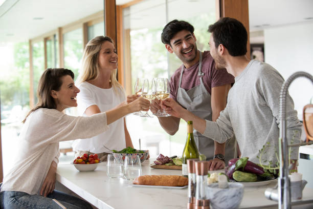 istock Smiling young friends toasting wine glasses 1310283488