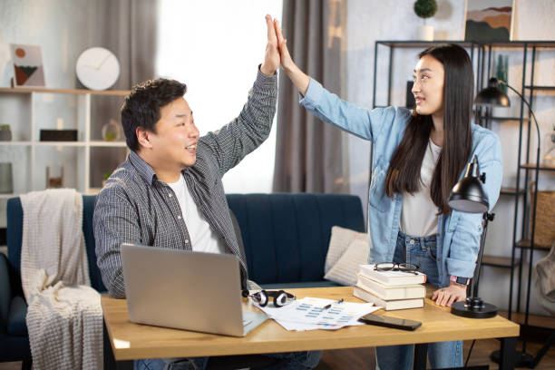 istock Happy freelancers giving high five after successful meeting 1310285016