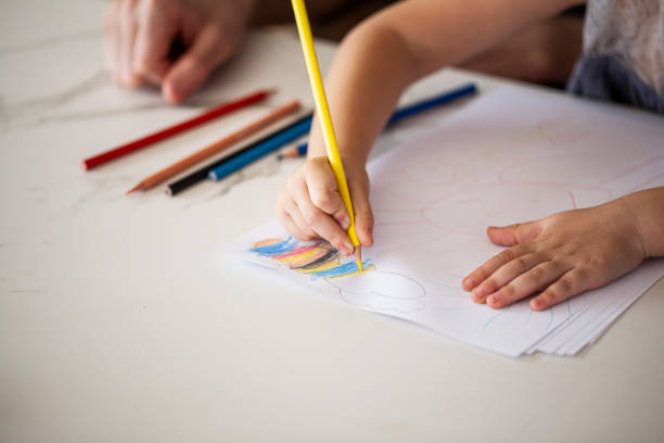 istock Girl drawing with coloured pencil 1310285032