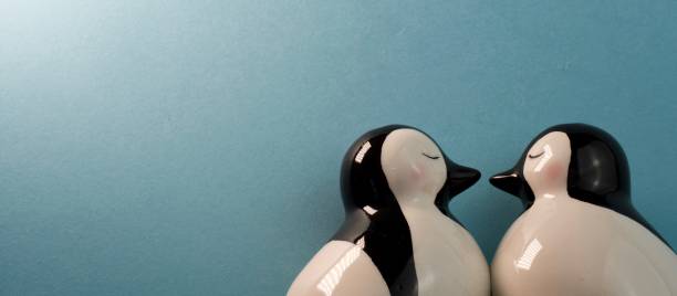 istock Banner of ceramic penguins kissing 1310285348
