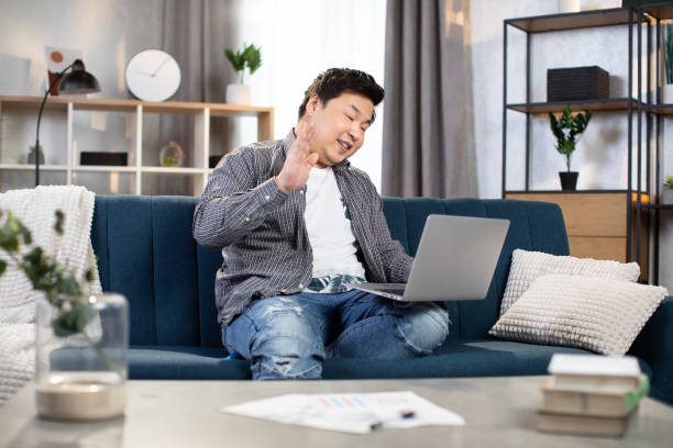 istock Asian man smiling and waving during video chat 1310288472