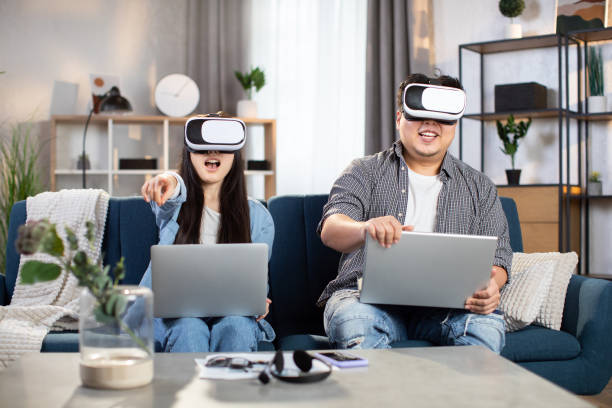 istock Asian couple using VR headset and laptop for playing games 1310289507