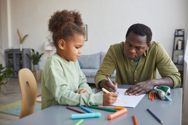 istock Father and Daughter Drawing Together 1310289516