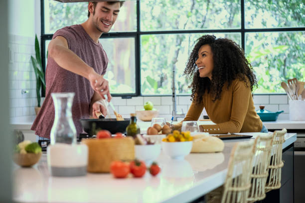 istock Smiling couple cooking in kitchen 1310289703