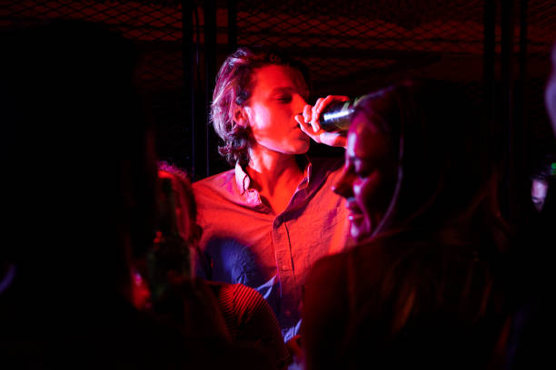 istock Young man drinking beer in nightclub 1310291748