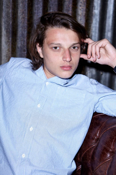 istock Young man sitting on sofa in club 1310291809