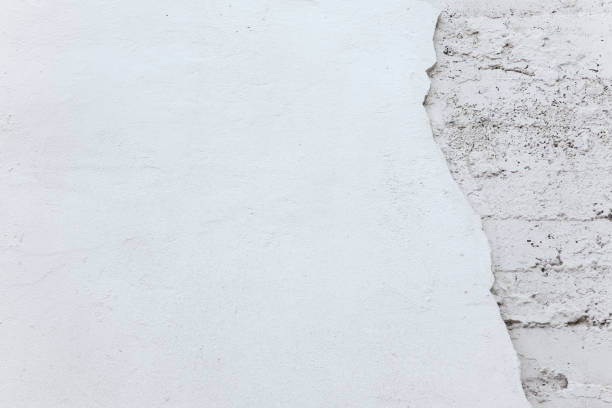 Texture and background. Ruined white old concrete wall
