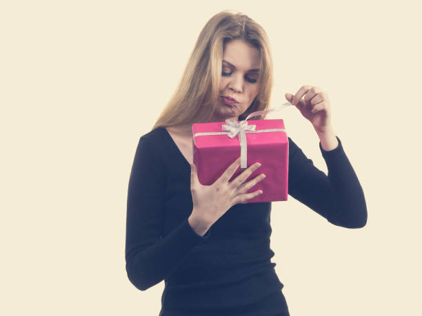 istock Girl opening pink gift box 1310296892