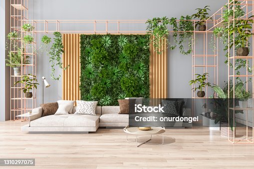 istock Green Living Room With Vertical Garden, House Plants, Beige Color Sofa And Parquet Floor 1310297075