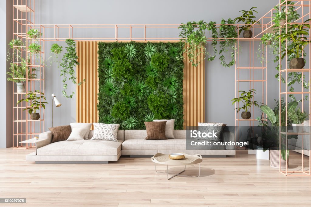 Green Living Room With Vertical Garden, House Plants, Beige Color Sofa And Parquet Floor Home Interior Stock Photo