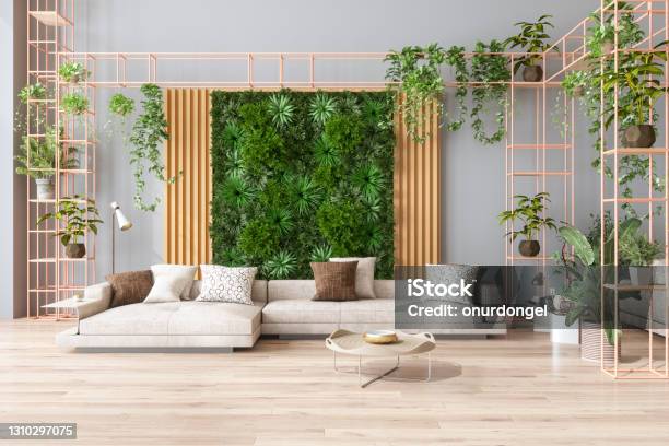 Green Living Room With Vertical Garden House Plants Beige Color Sofa And Parquet Floor Stock Photo - Download Image Now