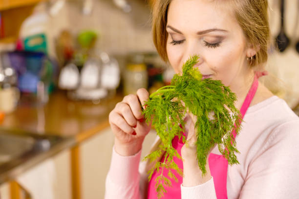 istock Woman smelling green dill herb 1310298204