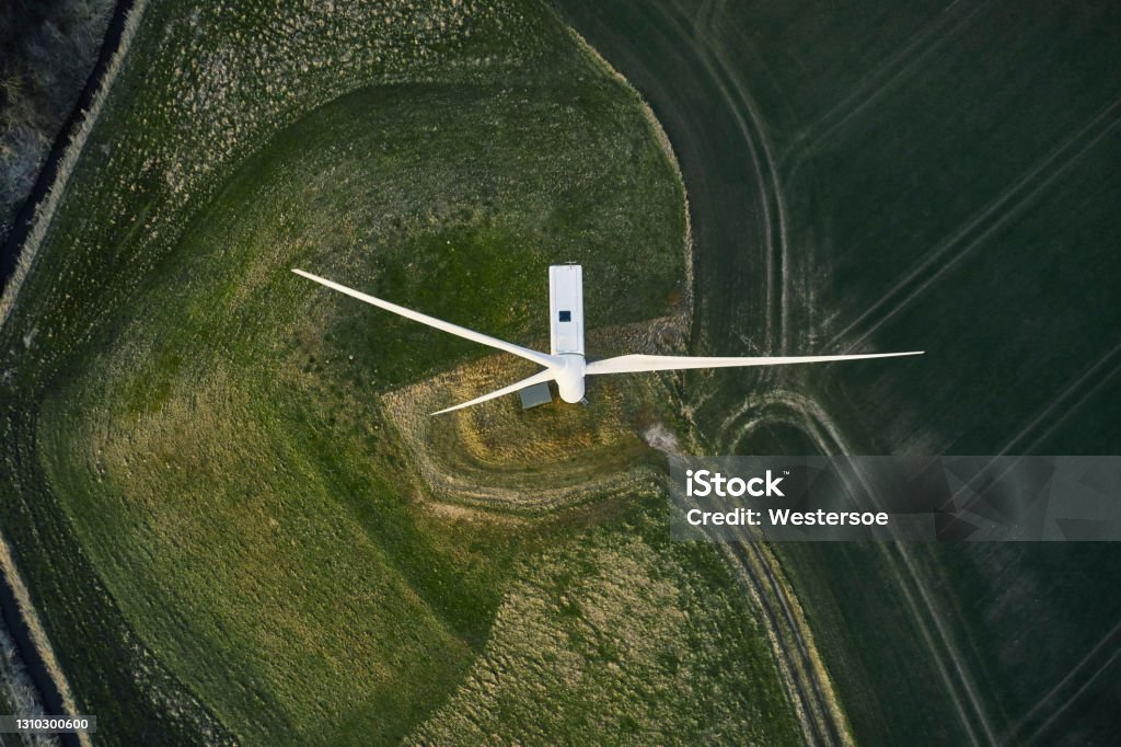 Wind turbines on field Night scene with wind mills. Wind turbines generating renewable energy. Aerial shot Wind Turbine Stock Photo