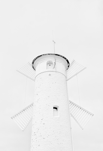 White windmill and lighthouse on a white background.