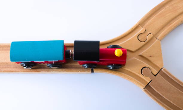 istock Wooden toy train approaching junction top view isolated on white 1310302377
