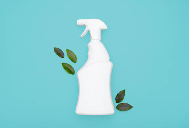 istock Spray bottle and green leaves on a blue background 1310303956