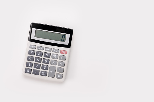 close up white calculator on white background for business financial concept. White digital calculator on the top view isolated on white background