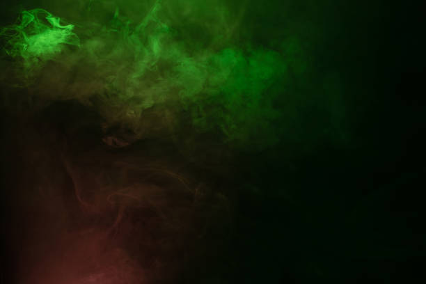 istock Green and pink steam on a black background. 1310305132