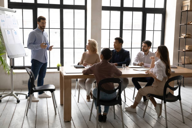 istock Male coach make whiteboard presentation at office meeting 1310305864