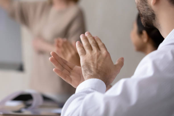 istock Close up of diverse employees applaud coach for training 1310305877