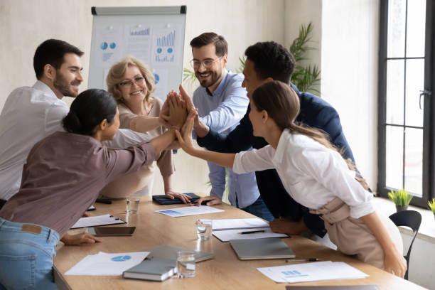 istock Excited diverse employees give high five at meeting 1310305883