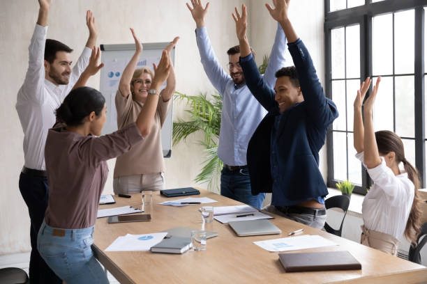 istock Excited diverse employees participate in teambuilding activity at meeting 1310305903