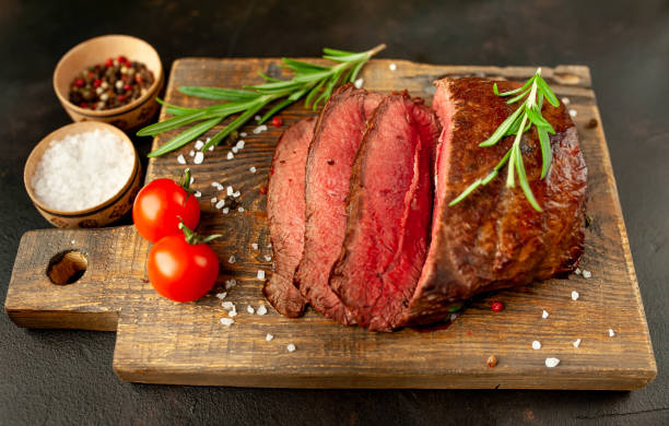 istock Grilled beef steak with spices on stone background 1310306439