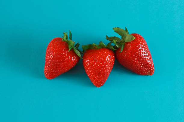 istock Strawberries isolated on a blue background 1310309387