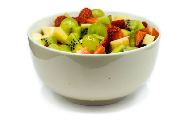 istock Fruit salad in bowl isolated on white background 1310309748