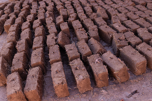 Mudbricks are dried in the sun in Morocco. A mud-brick is an air-dried brick, made of a mixture of loam, mud, sand and water mixed with a binding material such as rice husks or straw.