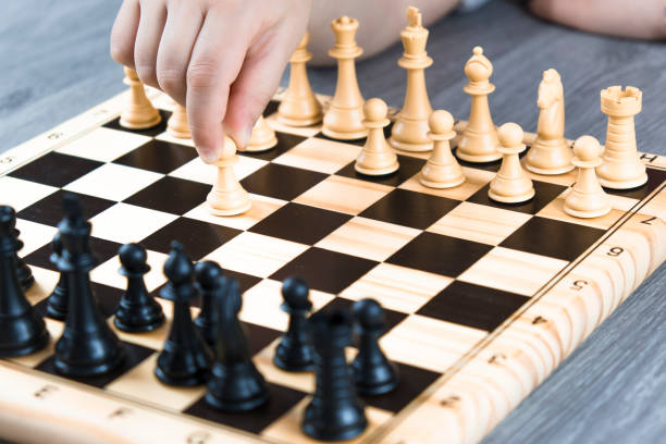 istock Hand of a woman starting chess game. 1310312112