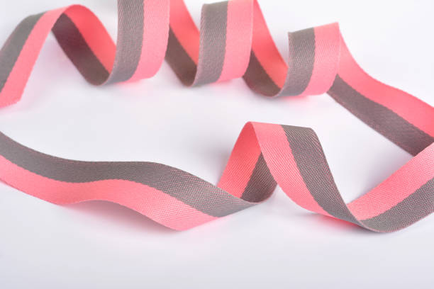 istock Pink and gray Cotton ribbon, roll textilies on bobbin. strapping tape and rope Lime Webbing with curl on white background. 1310312975