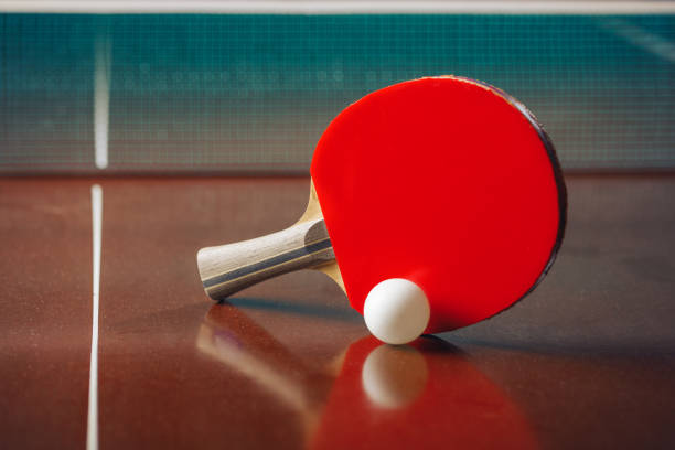 istock table tennis racket and ball, net background 1310313239