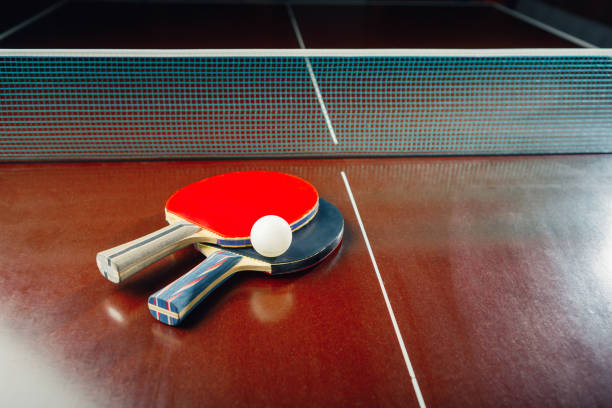 istock table tennis rackets and ball, net background 1310313253