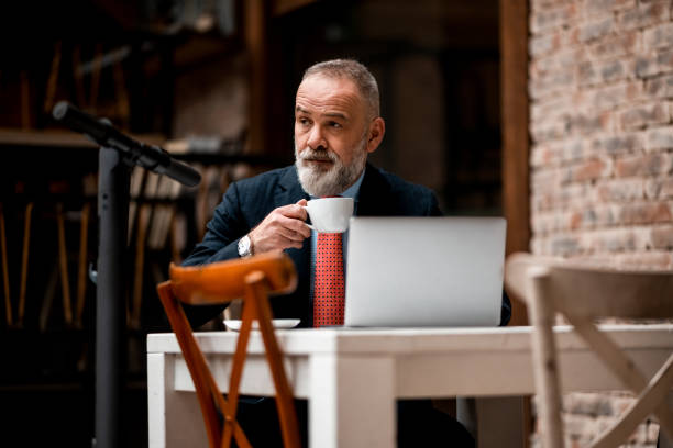 istock Elegant businessman enjoying coffee during work 1310314229