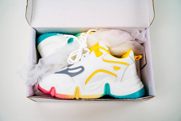 istock new multi-colored sneakers in box on a white background. 1310314670