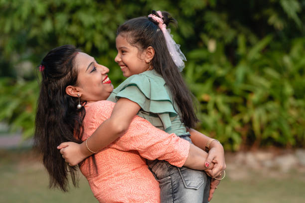 istock Mother and daughter having fun at nature park. 1310315375