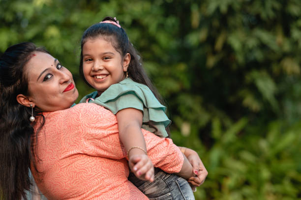 istock Mother and daughter having fun at nature park. 1310315403