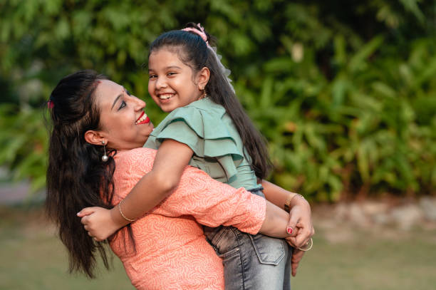 istock Mother and daughter having fun at nature park. 1310315418