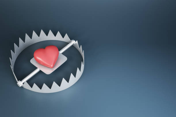 istock Heart trap concept with red heart in metallic trap on dark background with copyspace. 3D rendering, mock up 1310315835