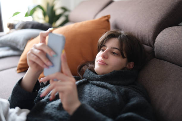 istock Young woman relaxing at home and using a smartphone. 1310318203