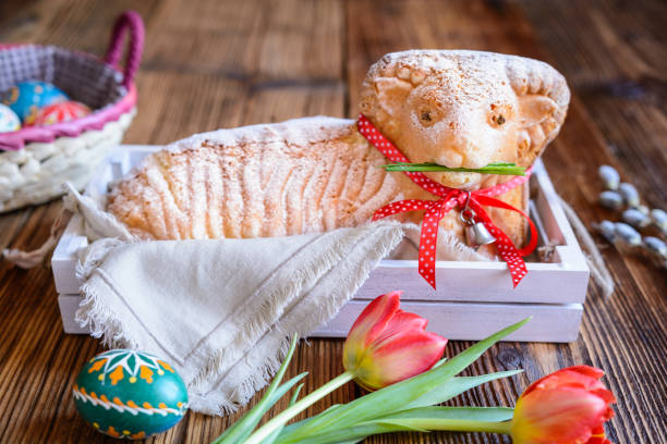 Classic Easter lamb pound cake sprinkled with powdered sugar Classic Easter lamb pound cake sprinkled with powdered sugar on wooden background easter cake photos stock pictures, royalty-free photos & images