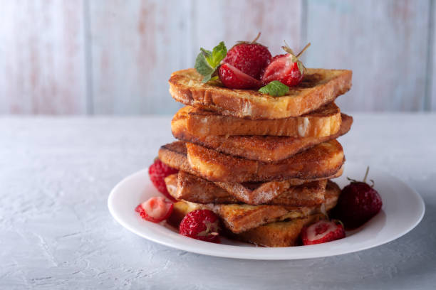 istock French toast with cinnamon, strawberries and mint for coffee or tea. Morning breakfast 1310319059
