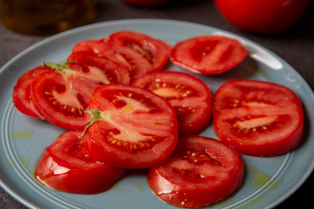 istock Dish with tomato sliced with oil 1310320730