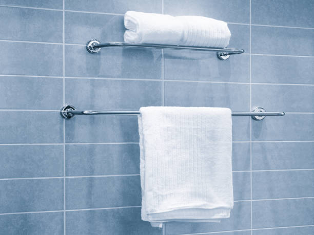White towel on hanger rack in  blue  bathroom