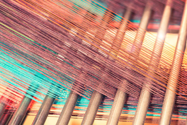 Multicolored straight strands texture background, sewing equipment, loom equipment at a garment factory